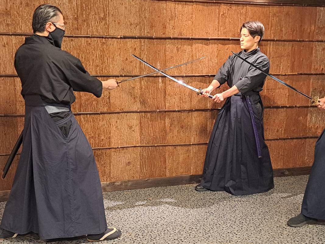 A family practicing samurai movements