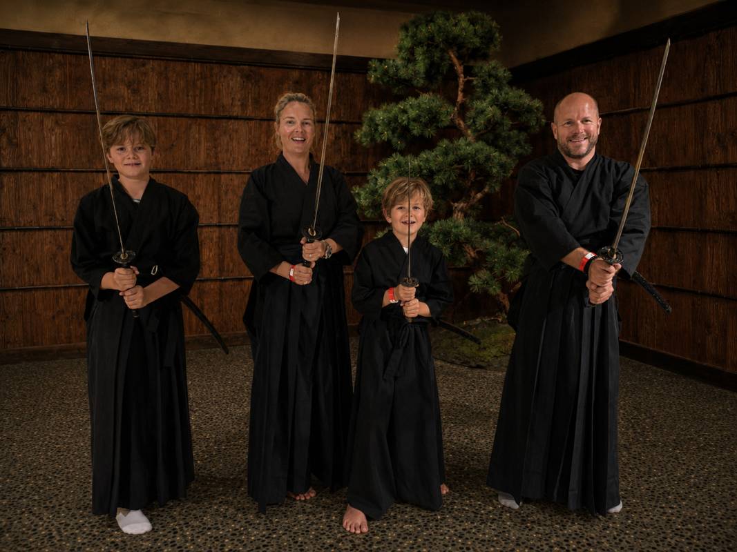 Family in samurai hakama holding katana at the Samurai Ninja Museum Asakusa Tokyo