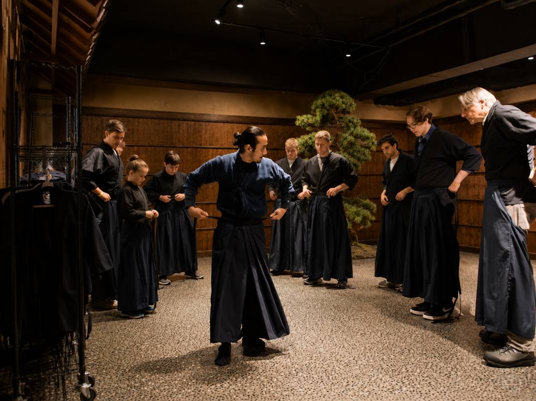 Guest wearing traditional hakama and kimono-style samurai attire before sword training in Asakusa