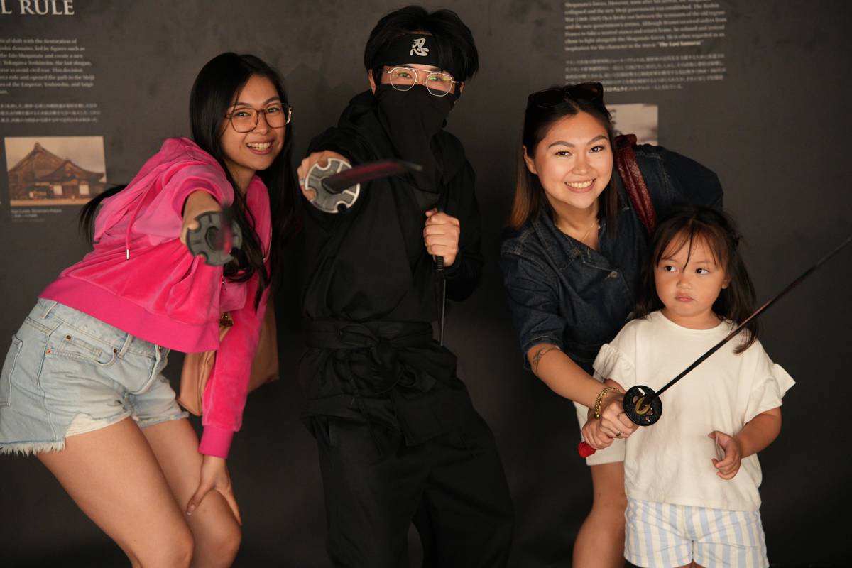 A family posing with the ninja cast after the show