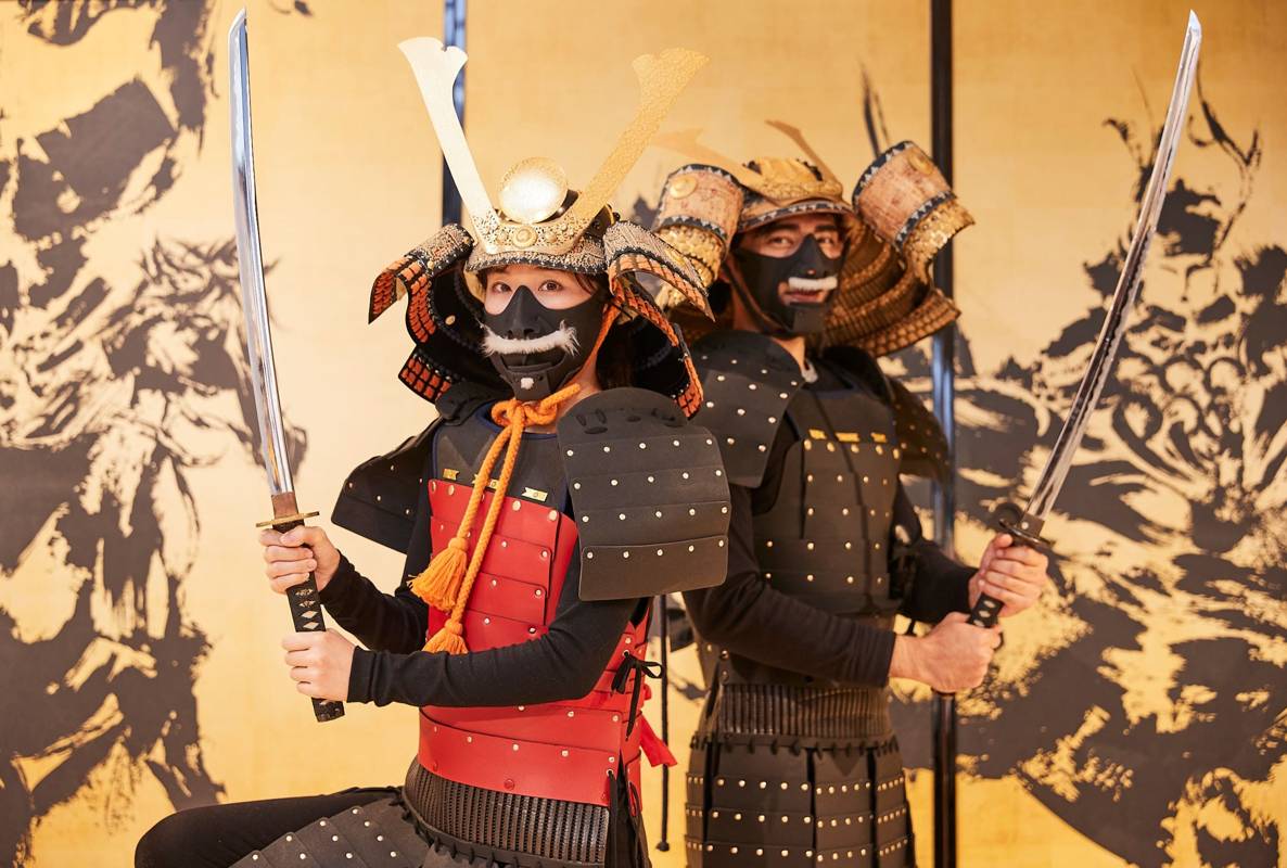 Guests posing in samurai armor costumes